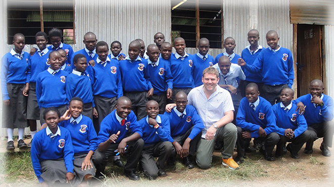 A teacher from Oure poses for a photo with one of the class he had just interacted with